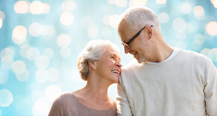 Image showing happy senior couple over blue holidays lights