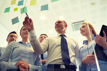 Image showing smiling business people with marker and stickers