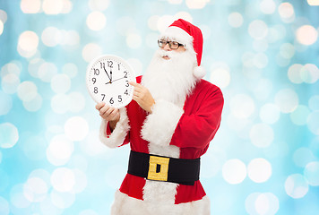 Image showing man in costume of santa claus with clock