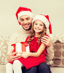 Image showing smiling father and daughter holding gift box