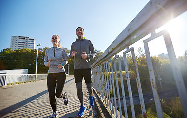 Image showing happy couple running outdoors