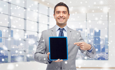 Image showing happy businessman in suit showing tablet pc screen