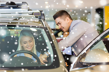 Image showing happy woman with car dealer in auto show or salon