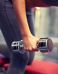 Image showing close up of couple with dumbbell exercising in gym