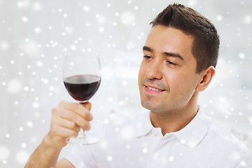 Image showing happy man drinking red wine from glass