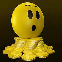 Image showing Surprised Smiley With Coins Shows Unexpected Earnings