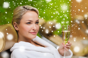 Image showing beautiful young woman drinking champagne at spa