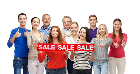 Image showing happy people with red sale sign showing thumbs up