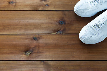 Image showing close up of sneakers on wooden floor