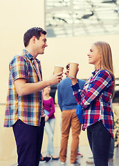 Image showing group of smiling students with paper coffee cups