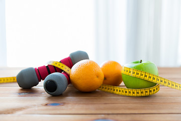 Image showing close up of dumbbell, fruits and measuring tape