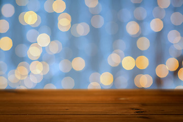 Image showing empty wooden table with christmas golden lights