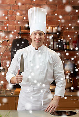 Image showing happy male chef cook in kitchen with knife