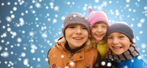 Image showing happy children hugging over snow background