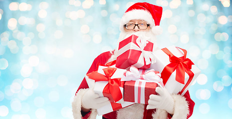 Image showing man in costume of santa claus with gift boxes