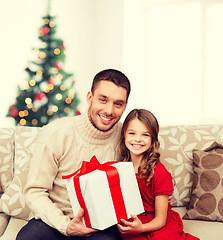 Image showing smiling father and daughter holding gift box