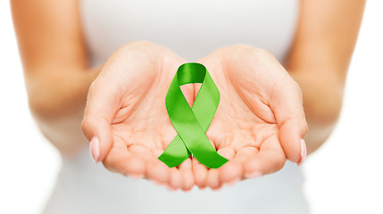 Image showing hands holding green awareness ribbon