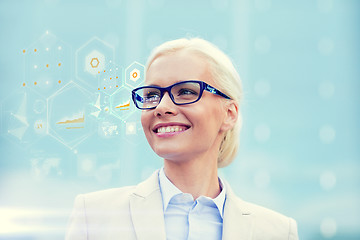 Image showing young smiling businesswoman in eyeglasses outdoors