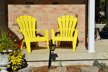 Image showing Two yellow wooden chairs.