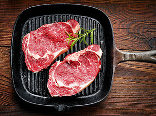 Image showing fresh raw beef steak on cooking pan