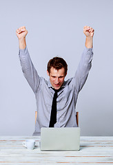 Image showing Happy man working on laptop in the office