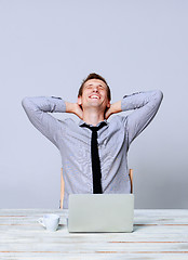 Image showing Happy man working on laptop in the office