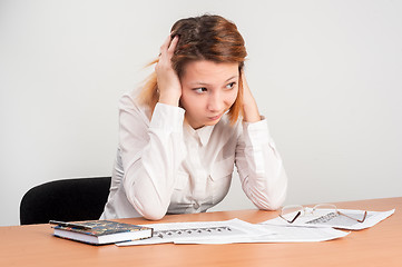 Image showing Young attractive student worried over charts