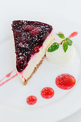 Image showing Cheesecake with raspberry sauce and green mint