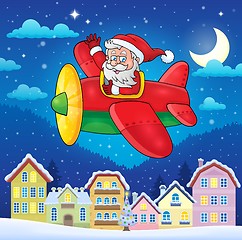 Image showing Christmas town with Santa Claus in plane