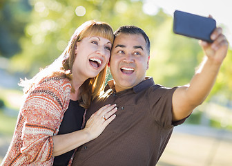 Image showing Attractive Mixed Race Couple Taking Self Portraits