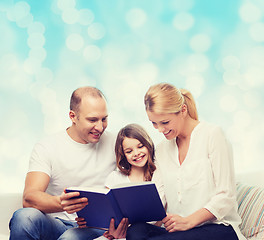 Image showing happy family with book at home