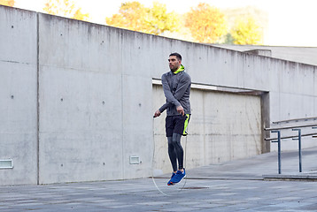 Image showing man exercising with jump-rope outdoors