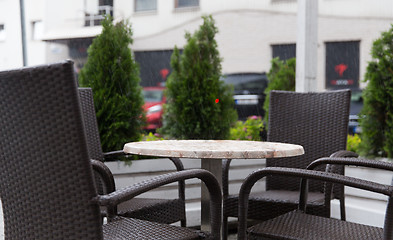 Image showing table and chairs on street cafe terrace under rain