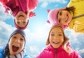 Image showing happy little children faces over blue sky