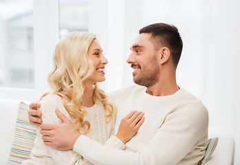 Image showing happy couple hugging on sofa at home