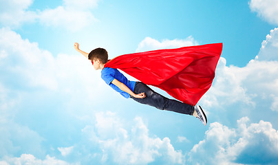 Image showing boy in red superhero cape and mask flying on air