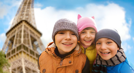 Image showing group of happy children hugging over eiffel tower