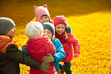 Image showing group of happy children hugging in autumn park