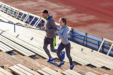 Image showing couple running upstairs on stadium