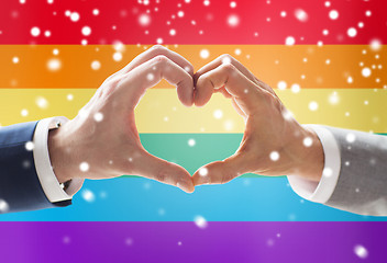 Image showing close up of male gay couple hands showing heart