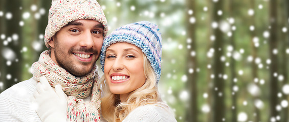 Image showing happy couple in winter wear over forest and snow