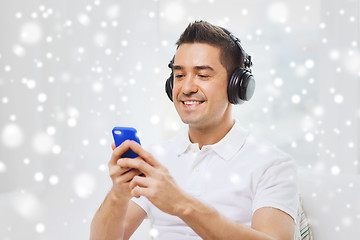 Image showing happy man with smartphone and headphones