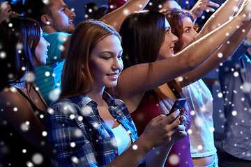 Image showing woman with smartphone texting message at concert