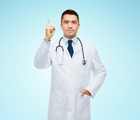 Image showing male doctor in white coat pointing finger up