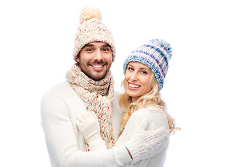 Image showing smiling couple in winter clothes hugging