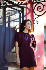 Image showing beautiful middle-aged woman near the ancient door