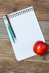 Image showing still life with notebook and apple