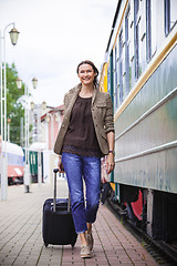 Image showing woman traveler with luggage walking on the platform