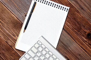 Image showing Computer keyboard, notebook and pen