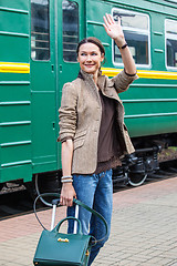 Image showing beautiful middle-aged woman waving good-bye